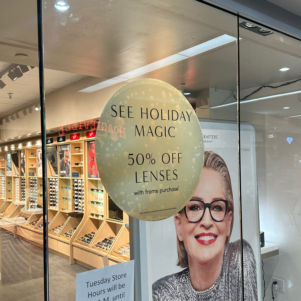 LensCrafters storefront cling signage that was printed by 760 Print in Vista CA, showcasing their special holiday deal of 50% off lenses when the frame is purchased.