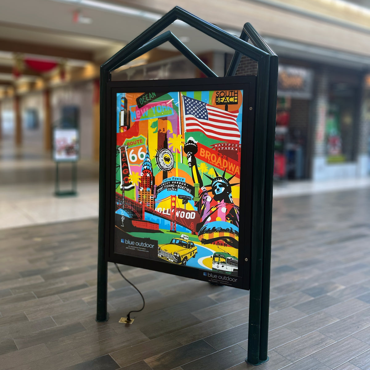 A custom backlit film display printed by 760 Print for a Blue Outdoor mall directory sign, showcasing vibrant, colorful marketing graphics.