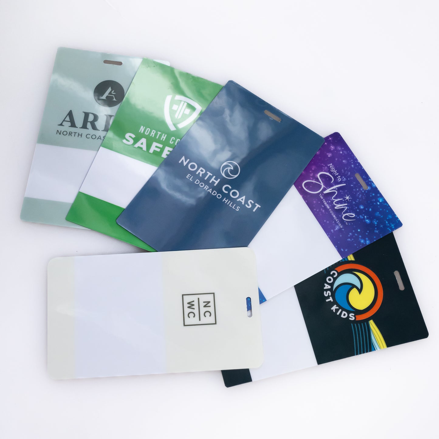 Custom printed plastic event name badges and corporate ID passes featuring vibrant full-color branding for various organizations, produced by 760 Print in Vista.