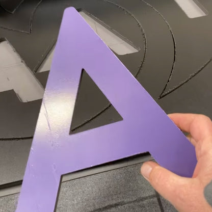 Large purple 'A' custom routed from the PVC board that was printed on and manufactured by 760 Print in Vista.