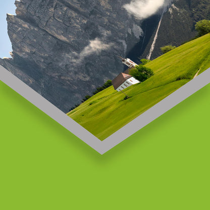 A custom cut green and gray angled Sintra board sign featuring a printed graphic of a house on a steep green hillside below mountains, manufactured by 760 Print.