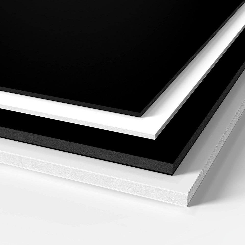 Black and white GatorFoam sheets stacked on each other and manufactured by 760 Print in Vista. 