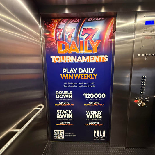 An elevator wrap advertisement for Pala Casino in San Diego, featuring vibrant graphics with text promoting daily tournaments at a casino, showcasing elements such as slot machines and weekly winnings.