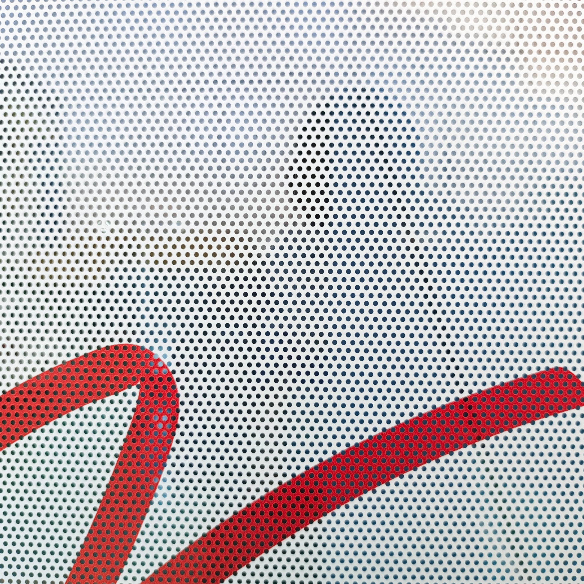A close-up of a custom perforated vinyl window wrap printed by 760 Print, featuring the recognizable red Virgin brand script logo design.